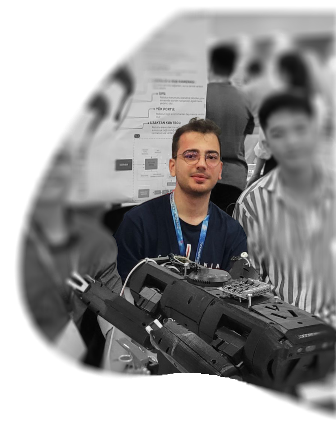 Utku Arslan beside his quadruped robotics project